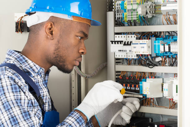 Our Services young african male technician repairing fusebox with screwdriver